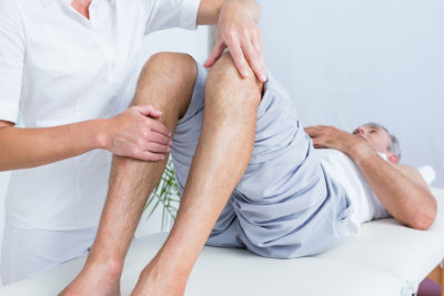 caregiver and senior man having physical therapy